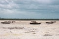 Wooden boats on low tide, toned. Zanzibar beach with old nautical vessel. African seascape with cloudy sky. Empty coast of ocean. Royalty Free Stock Photo