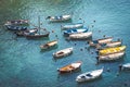 Wooden boats moored in the middle of the sea. Small port of fishing boats. Intense blue sea. Different colors Royalty Free Stock Photo