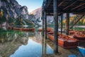 Wooden boats near the house in Braies lake at sunrise in autumn Royalty Free Stock Photo