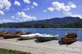 Wooden boats on the pier on the background of the castle on Lake Bled. Beautiful view, nature, calm Royalty Free Stock Photo