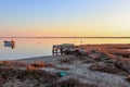 wooden boats sailing on the river in a fishing village from an old pier at sunset Royalty Free Stock Photo