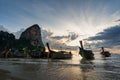 Wooden boats at the shore at the Rai Leh Beach with the sunset in the background on Krabi, Thailand Royalty Free Stock Photo