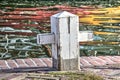 Wooden bollard and colorful reflection Royalty Free Stock Photo