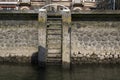 Wooden bollard with stairs in the Rotterdam harbour Royalty Free Stock Photo