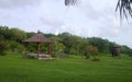 Wooden bolon garden on green meadows with trees and blue sky