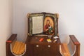 Wooden book with icon of the Virgin Mary and candles