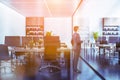 Wooden bookcases office with glass wall, man Royalty Free Stock Photo