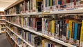 Wooden bookshelves with various type of books in the library