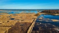 Wooden Bords Trail Through the Kaniera Lake Reeds Aerial Spring Shot Lapmezciems, Latvia. Royalty Free Stock Photo