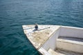 Wooden bow of moored old boat against the background of the blue sea. Copy space. Royalty Free Stock Photo