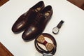 Wooden bow tie, brown leather shoes, belt, watch. Grooms wedding morning. Close up of modern man accessories Royalty Free Stock Photo