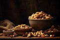 A wooden bowl with assorted nuts on the table on a black background. Walnuts, pistachios, almonds, hazelnuts and cashews Royalty Free Stock Photo