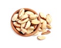 Wooden bowl with Brazil nuts on white background Royalty Free Stock Photo