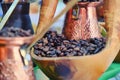 Wooden bowl with coffee beans and copper turk for his cooking Royalty Free Stock Photo