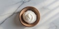 Wooden bowl with cream on marble background Royalty Free Stock Photo