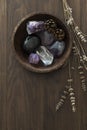 Wooden Bowl with Crystal and Stone Collection next to Dried Lavender