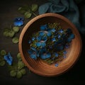 wooden bowl on a dark boho background, flowers and airy fabric, top view