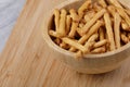 Wooden bowl of delicious mini pretzels sticks Royalty Free Stock Photo