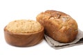 Wooden bowl of dough and freshly baked loaf on white Royalty Free Stock Photo