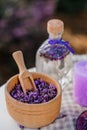 Wooden bowl with dried lavender on field background. Flower herbal tea drink. Aromatherapy, medicine ingredient. Calming beverage Royalty Free Stock Photo