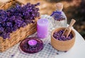 Wooden bowl with dried lavender on field background. Flower herbal tea drink. Aromatherapy, medicine ingredient. Calming beverage Royalty Free Stock Photo