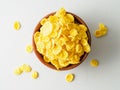 wooden bowl with dry cereal for breakfast, top view, gray background.