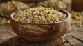 A wooden bowl filled with dried chamomile flowers commonly used in herbal infusions for its calming effects on the mind