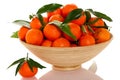 Wooden bowl filled with fresh orange mandarin citrus fruit with Royalty Free Stock Photo