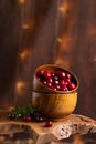 Wooden bowl filled with fresh, ripe red cherries atop a rustic wooden table Royalty Free Stock Photo