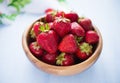 Wooden bowl filled with fresh ripe strawberries Royalty Free Stock Photo