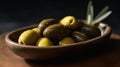 a wooden bowl filled with green olives on a wooden table with an olive sprig in the middle of the bowl and a black background Royalty Free Stock Photo