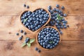 Wooden bowl with fresh blueberry on rustic table top view. Organic superfood and healthy berry Royalty Free Stock Photo