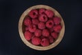 A wooden bowl of fresh raspberries Royalty Free Stock Photo