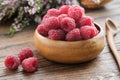 Wooden bowl of fresh red raspberries on table Royalty Free Stock Photo