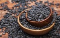 Wooden bowl full of black sunflower seeds on wooden background with copy space Royalty Free Stock Photo