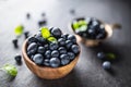 Wooden bowl full of fresh blueberries with herbs Royalty Free Stock Photo