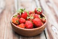 Wooden bowl full of fresh strawberries