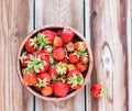 Wooden bowl full of fresh strawberries