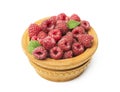 Wooden bowl full of freshly picked raspberries on white table. Royalty Free Stock Photo