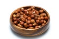 Wooden bowl full of hazelnuts on white background. Healthy eating concept. Super foods.