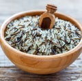 Wooden bowl full of wild and white rice close-up. Royalty Free Stock Photo