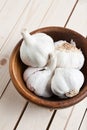 Wooden bowl with heads of garlic Royalty Free Stock Photo