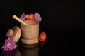 Wooden bowl with honey dipper dripping honey with flowers Royalty Free Stock Photo