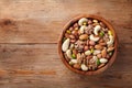 Wooden bowl with mixed nuts on rustic table top view. Healthy food and snack Royalty Free Stock Photo