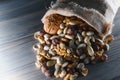 Wooden bowl with mixed nuts on rustic table top view. Healthy food and snack. Royalty Free Stock Photo