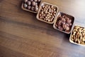 Wooden bowl with mixed nuts on table top view. Healthy food and snack. Walnut, pistachios, almonds, hazelnuts and Royalty Free Stock Photo