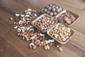 Wooden bowl with mixed nuts on table top view. Healthy food and snack. Walnut, pistachios, almonds, hazelnuts and Royalty Free Stock Photo