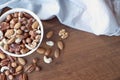 Wooden bowl with mixed nuts on table top view. Healthy food and snack. Walnut, pistachios, almonds, hazelnuts and Royalty Free Stock Photo