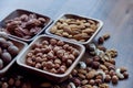 Wooden bowl with mixed nuts on table top view. Healthy food and snack. Walnut, pistachios, almonds, hazelnuts and Royalty Free Stock Photo