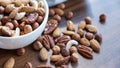 Wooden bowl with mixed nuts on table top view. Healthy food and snack. Walnut, pistachios, almonds, hazelnuts and Royalty Free Stock Photo